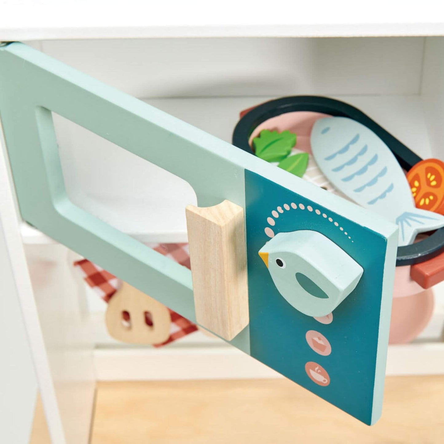 Children's toy kitchen set with a green spatula and pink pot on a white background