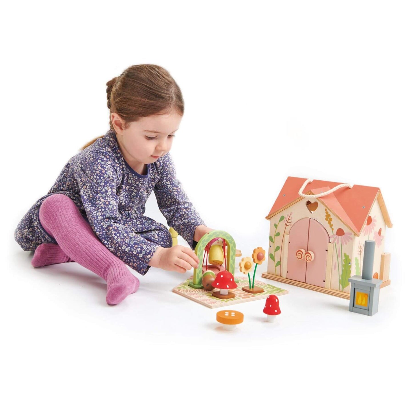 Child playing with Tender Leaf Rosewood Cottage on a white background