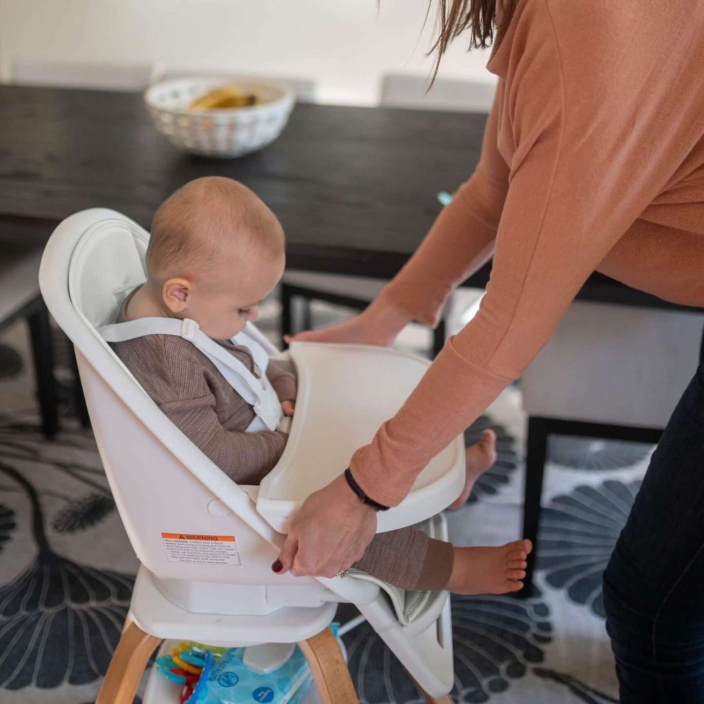 Mom Setting up TruBliss 2-in-1 Turn-A-Tot Highchair with 360° Swivel Cream for Baby