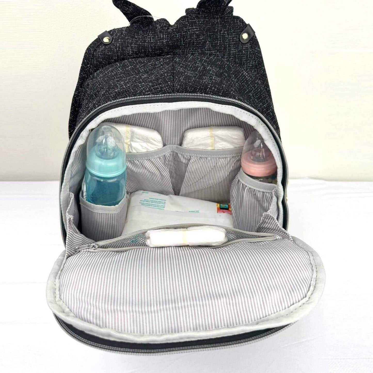 Sunveno Tweed Luxe Diaper Bag Backpack - Black with baby items organized inside
