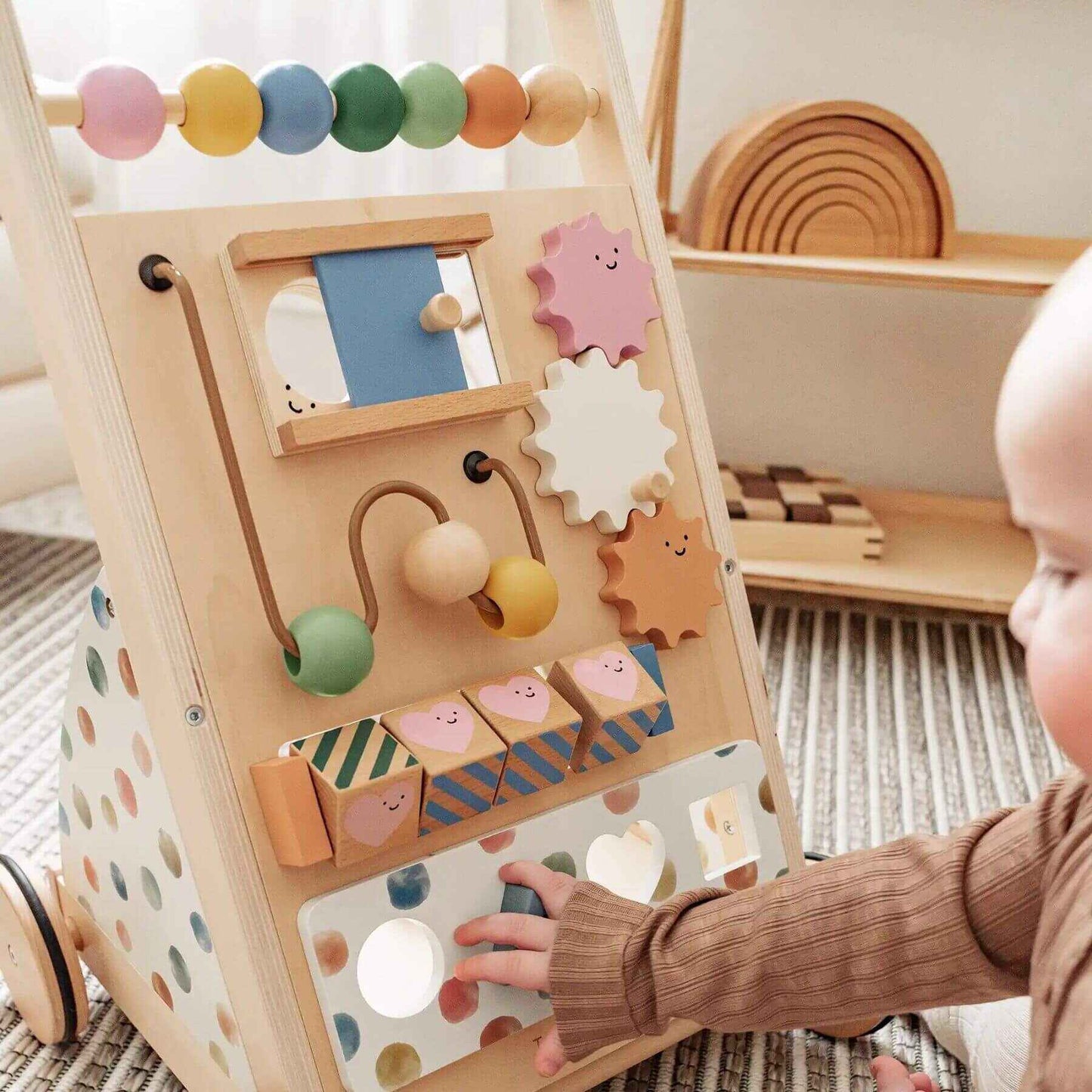 Child playing with Tiny Land® Versatile Natural Wooden Baby Walker on a carpeted floor
