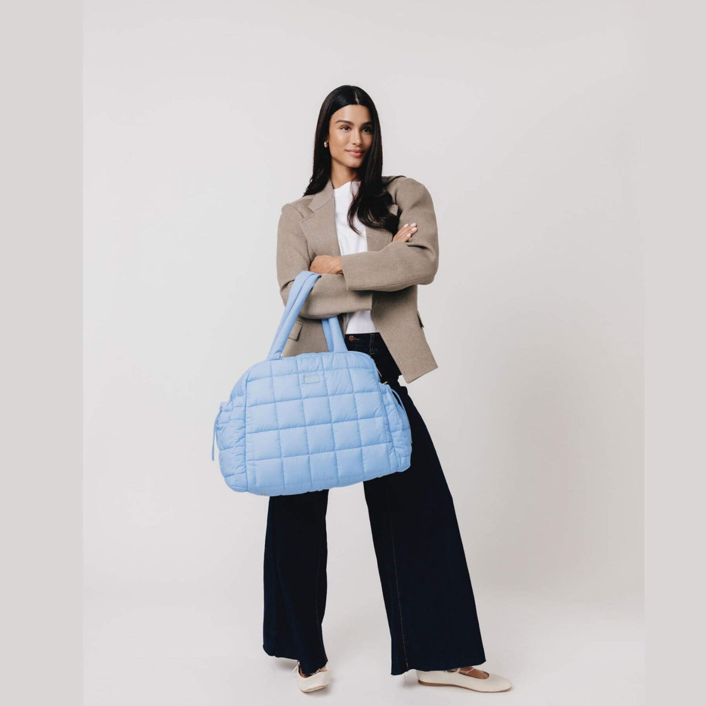 Woman holding augustnoa the weekender duffle bag blue