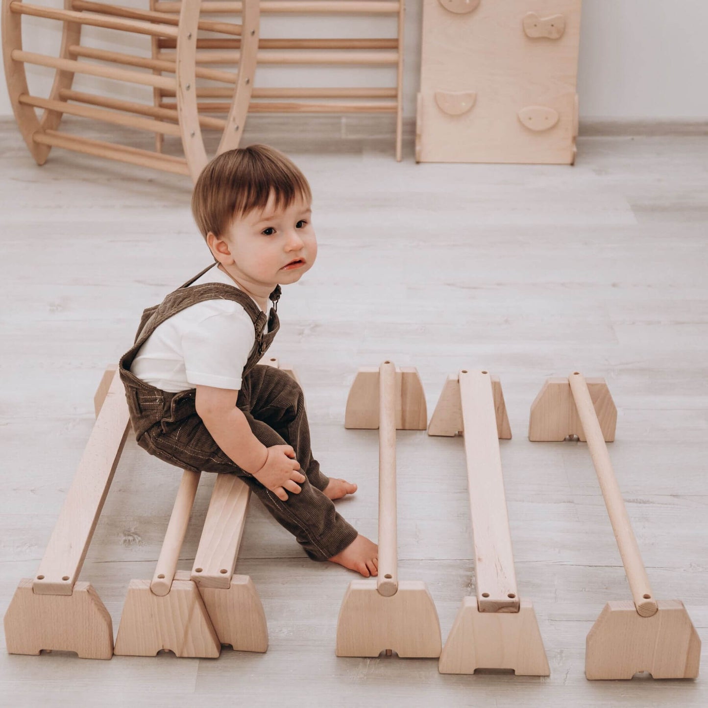 Boy Sitting on Wood and Hearts Balance Beam Set