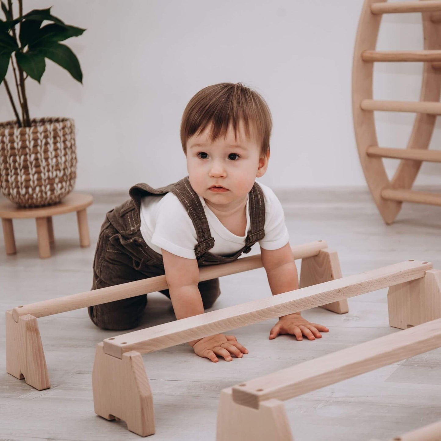 Boy Playing Wood and Hearts Balance Beam Set