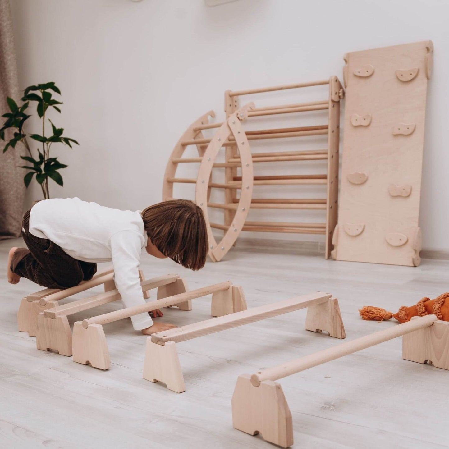 Boy Playing Wood and Hearts Balance Beam Set