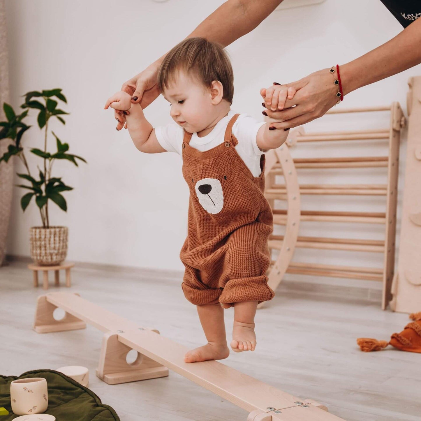 Parent Holding Boy Walking on Wood and Hearts Balance Beam Straight