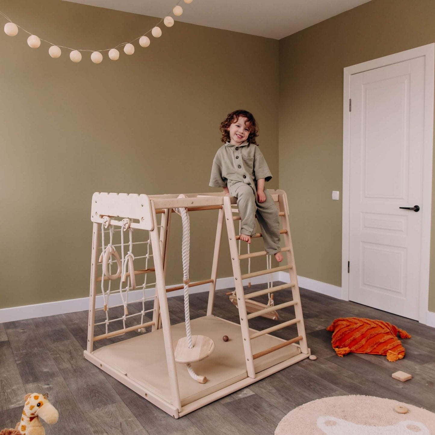 Kid Sitting on the top of Wood and Hearts Indoor Jungle Gym - Trapeze + 4 Rope