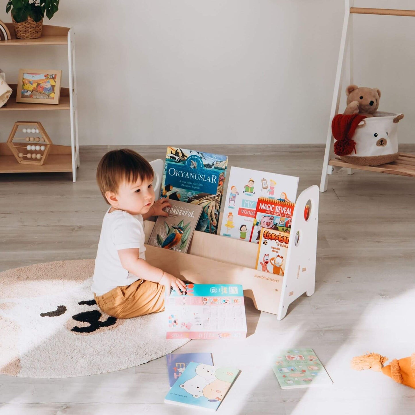 Boy Getting Books from Wood and Hearts Kids Bookshelf in White & Natural Wood