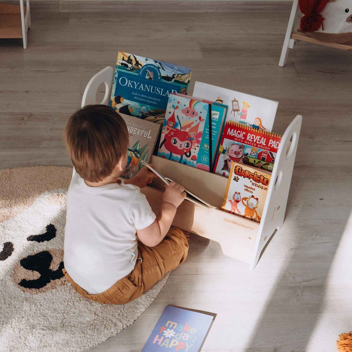 Boy Getting a Book from Wood and Hearts Kids Bookshelf in White & Natural Wood