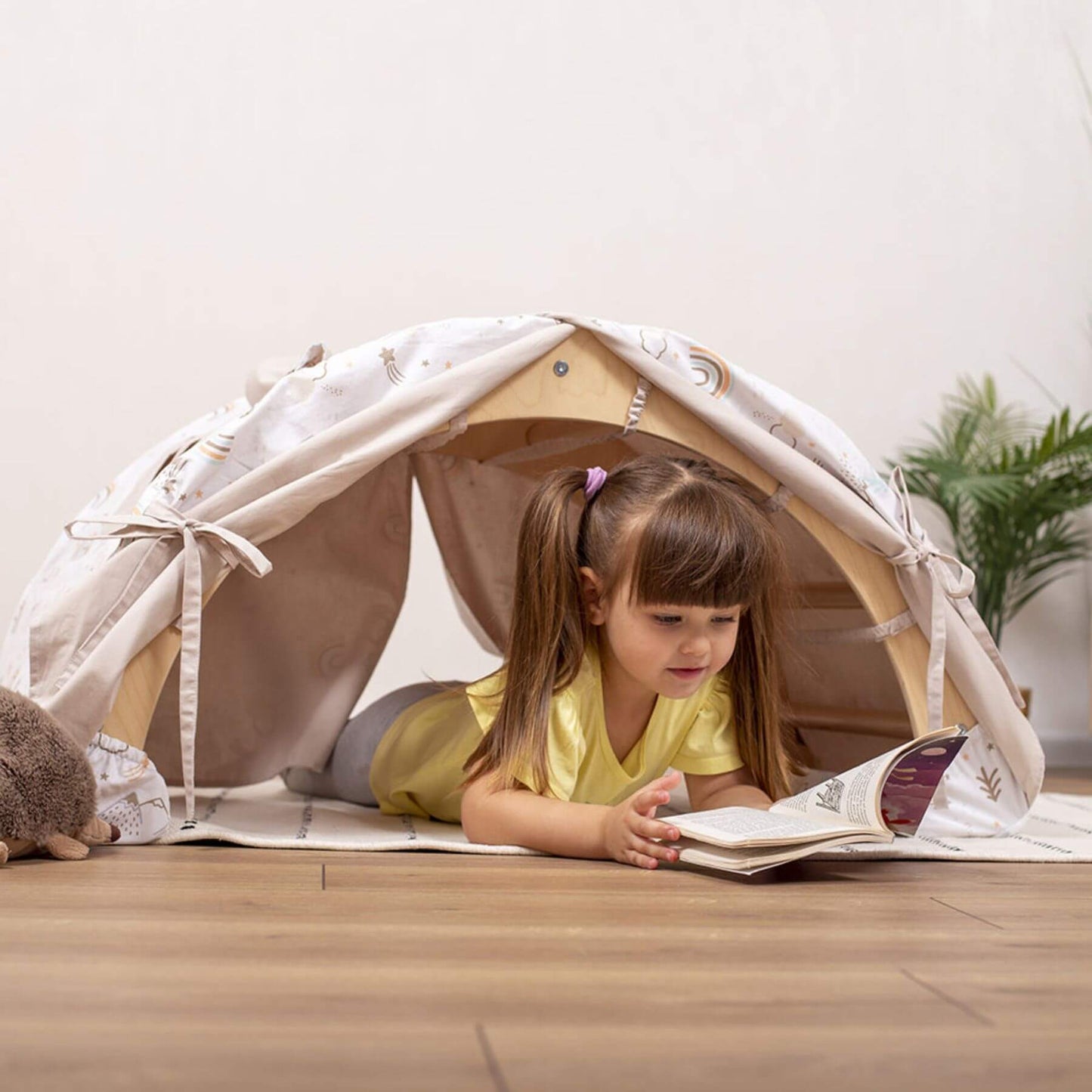 Girl Reading Under Wood and Hearts Large Climbing Arch w/ Tent Spring Hiking