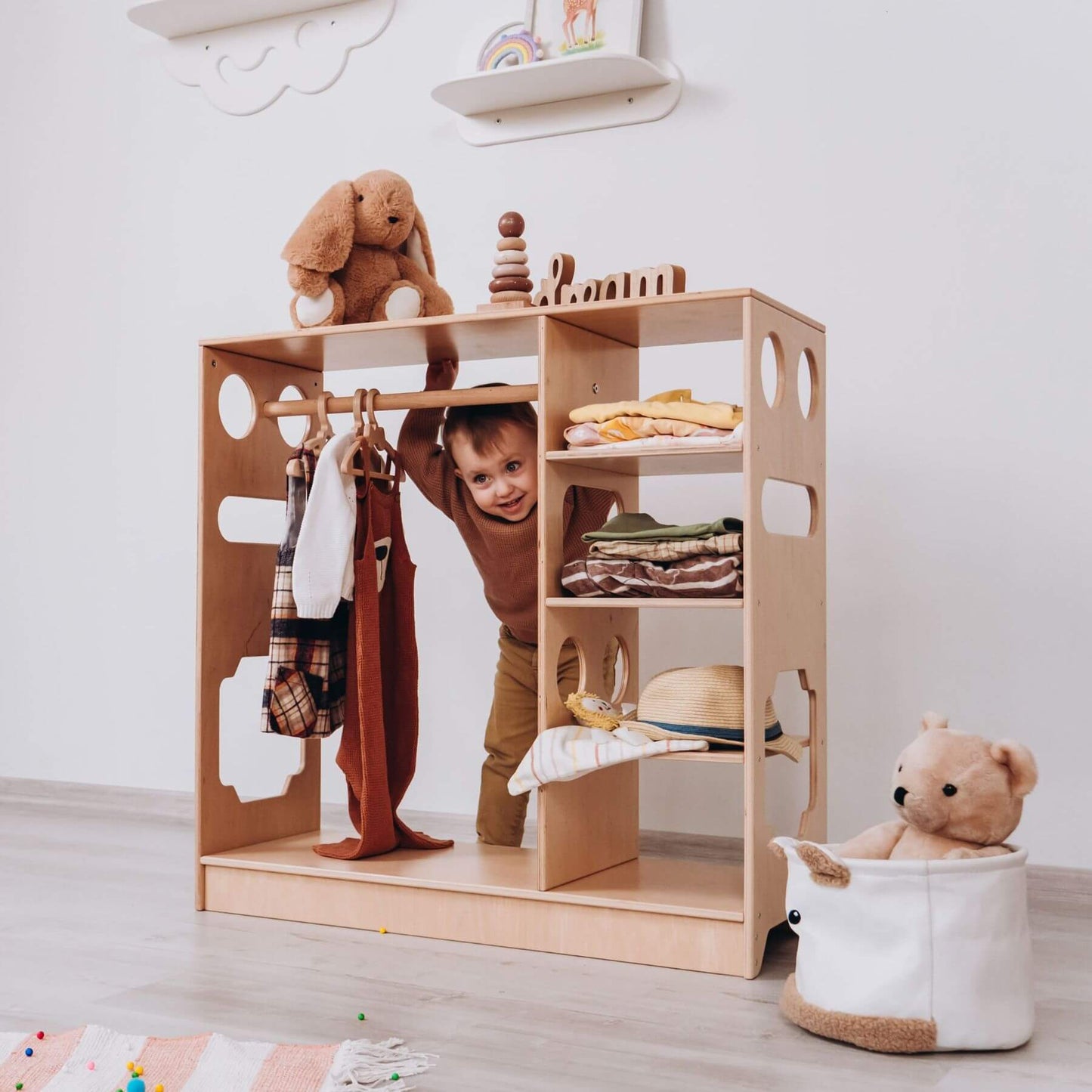 Boy Standing Behind Wood and Hearts Montessori Closet