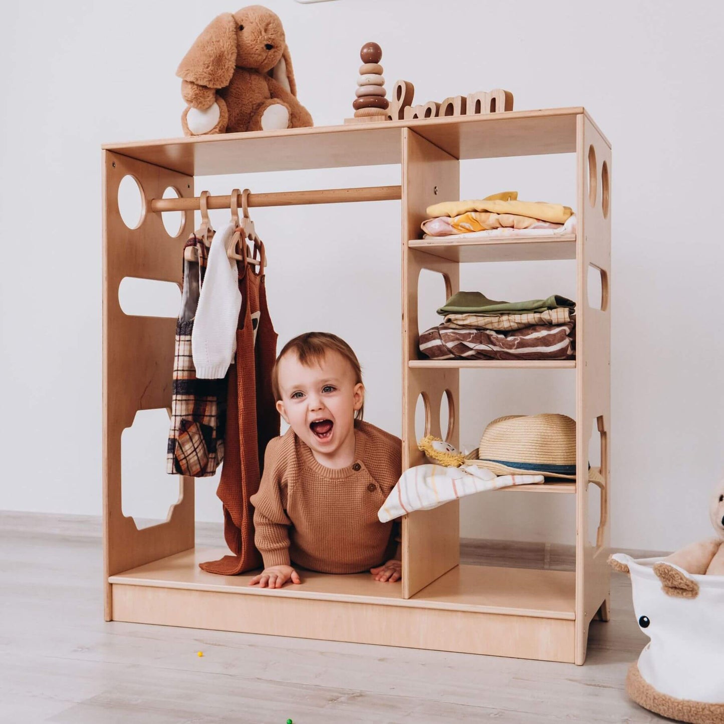 Boy Coming out from Wood and Hearts Montessori Closet