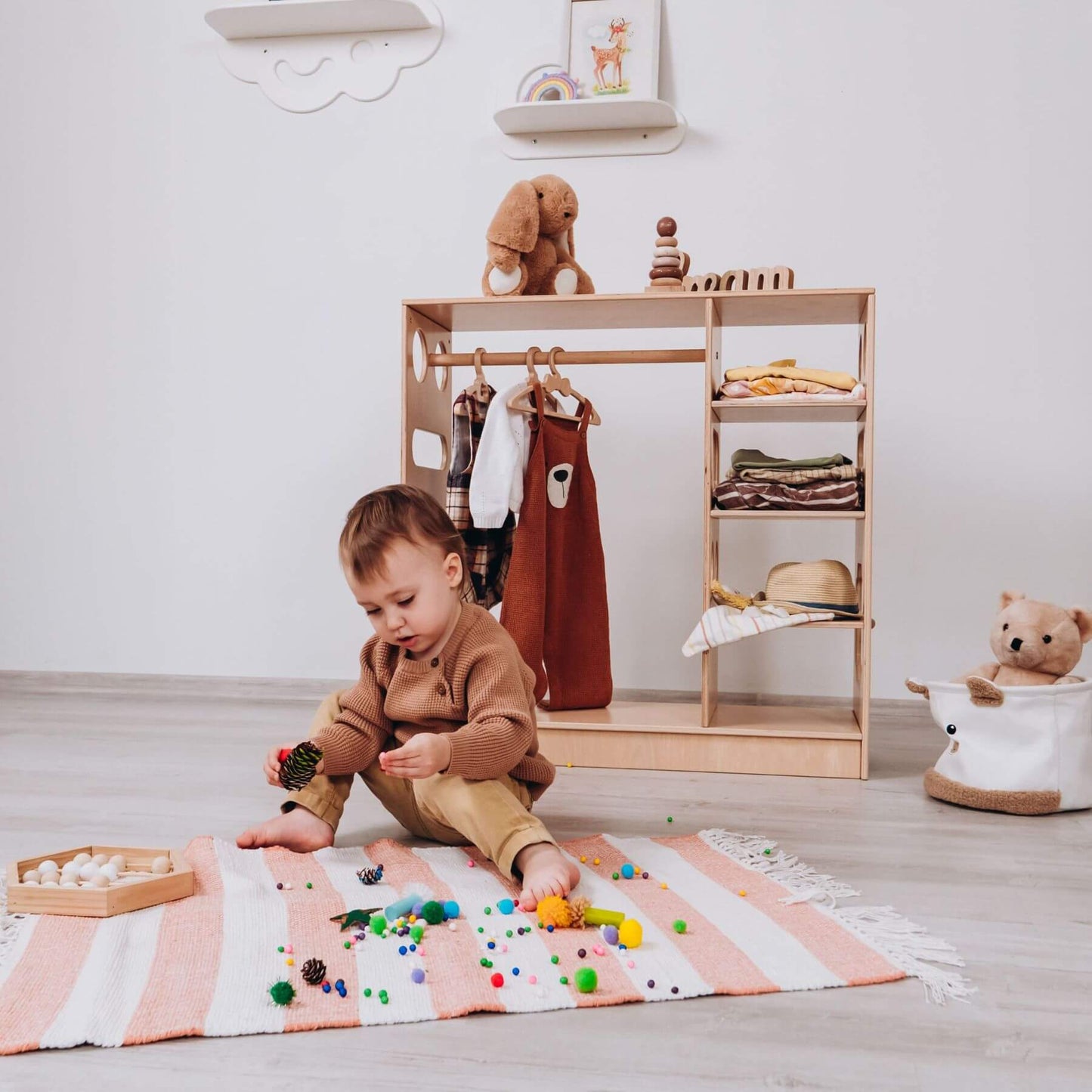 Boy Playing in front of Wood and Hearts Montessori Closet