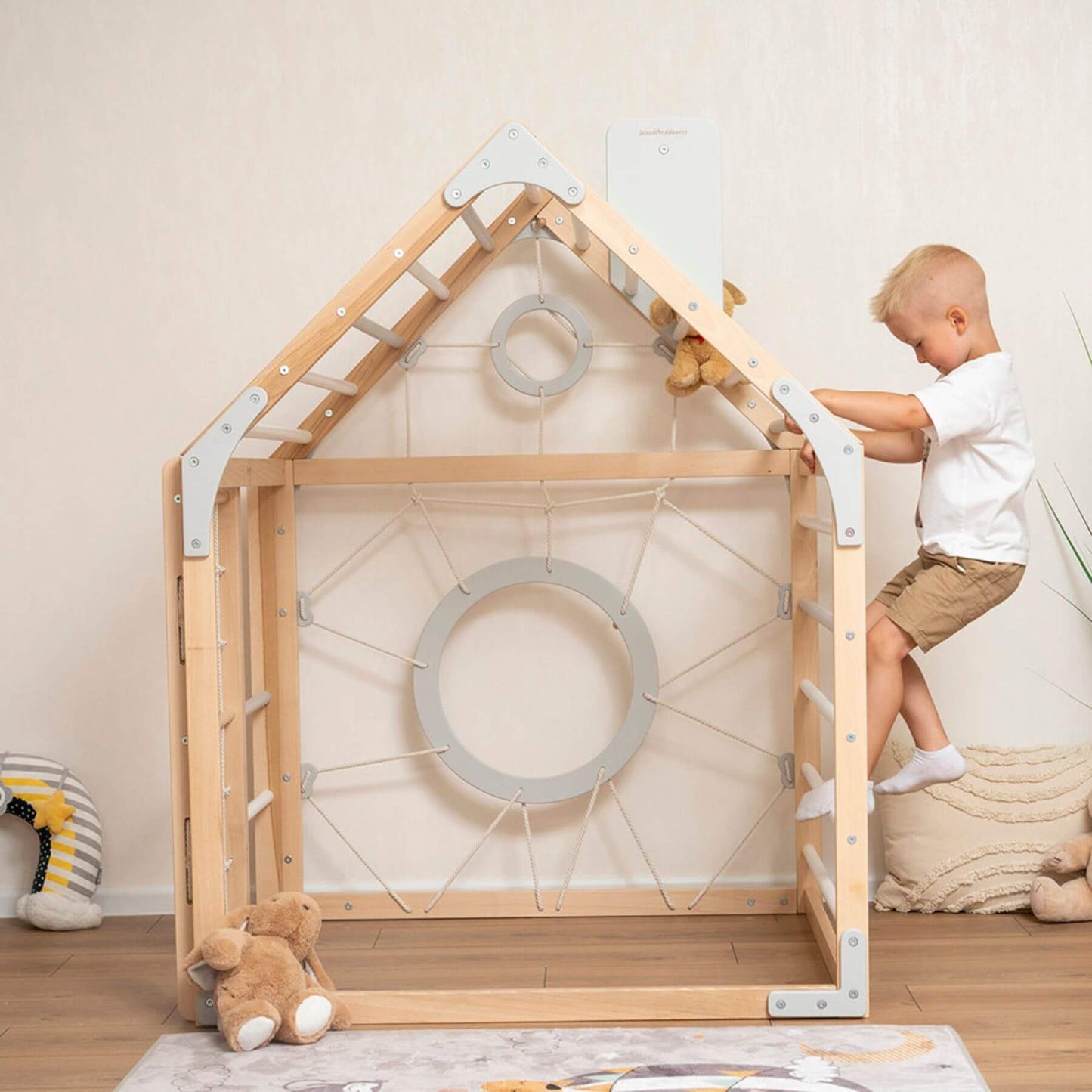 Boy Playing on Wood and Hearts Wooden Climbing Playhouse Natural & Grey