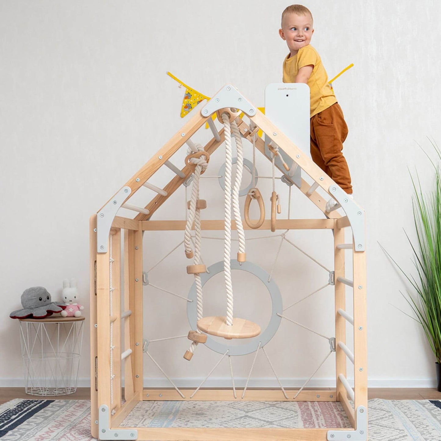 Boy Playing on Wood and Hearts Wooden Climbing Playhouse Natural & Grey