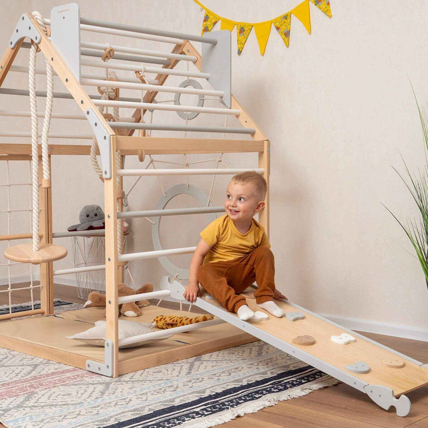 Boy Playing on Wood and Hearts Wooden Climbing Playhouse Natural & Grey