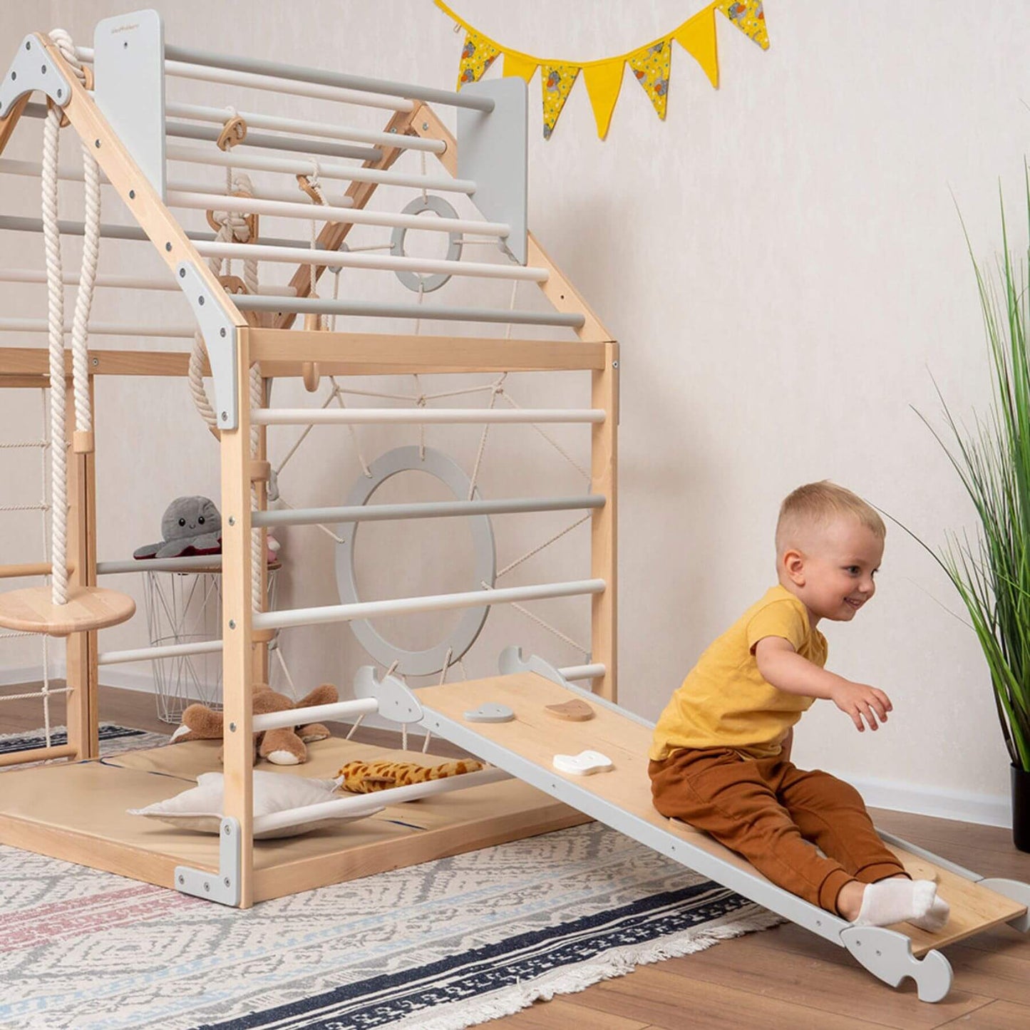 Boy Playing on Wood and Hearts Wooden Climbing Playhouse Natural & Grey