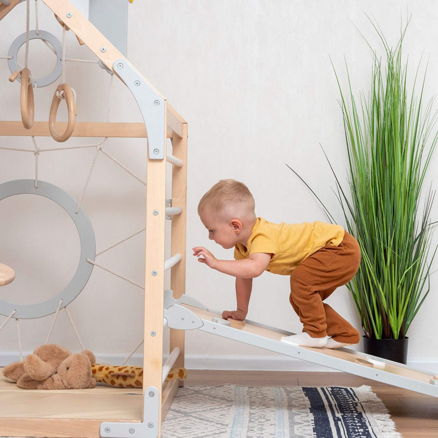 Boy Playing on Wood and Hearts Wooden Climbing Playhouse Natural & Grey