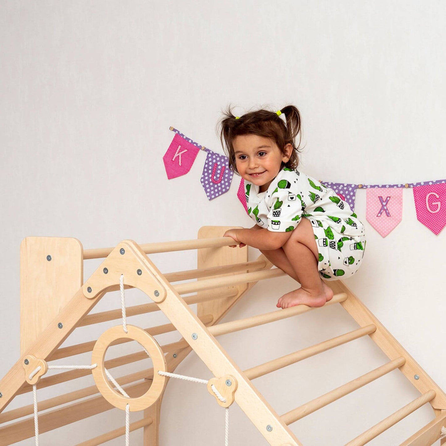 Girl Climbing on Wood and Hearts Wooden Climbing Playhouse w/ Ramp Natural