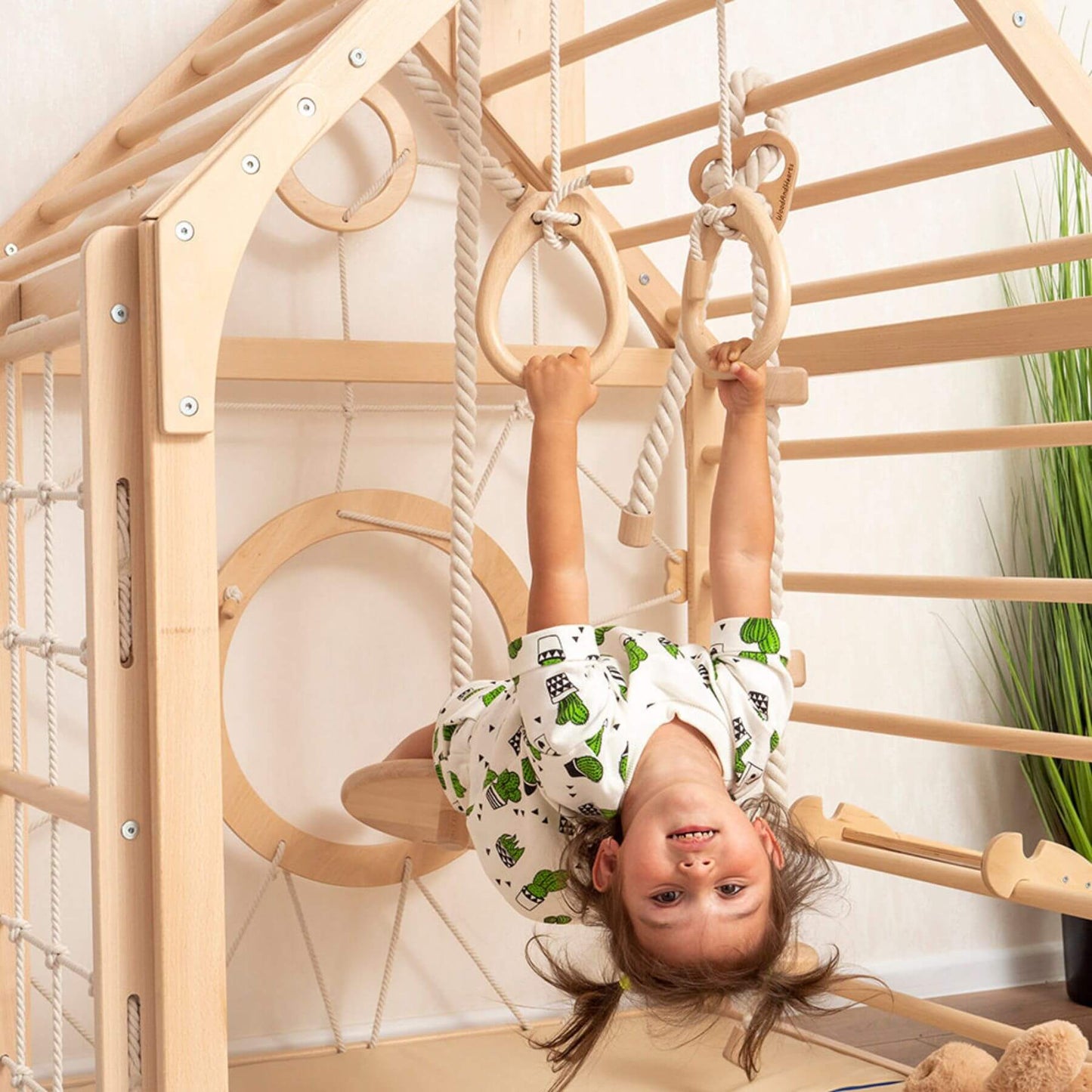 Girl Playing on Wood and Hearts Wooden Climbing Playhouse w/ 3 Ropes