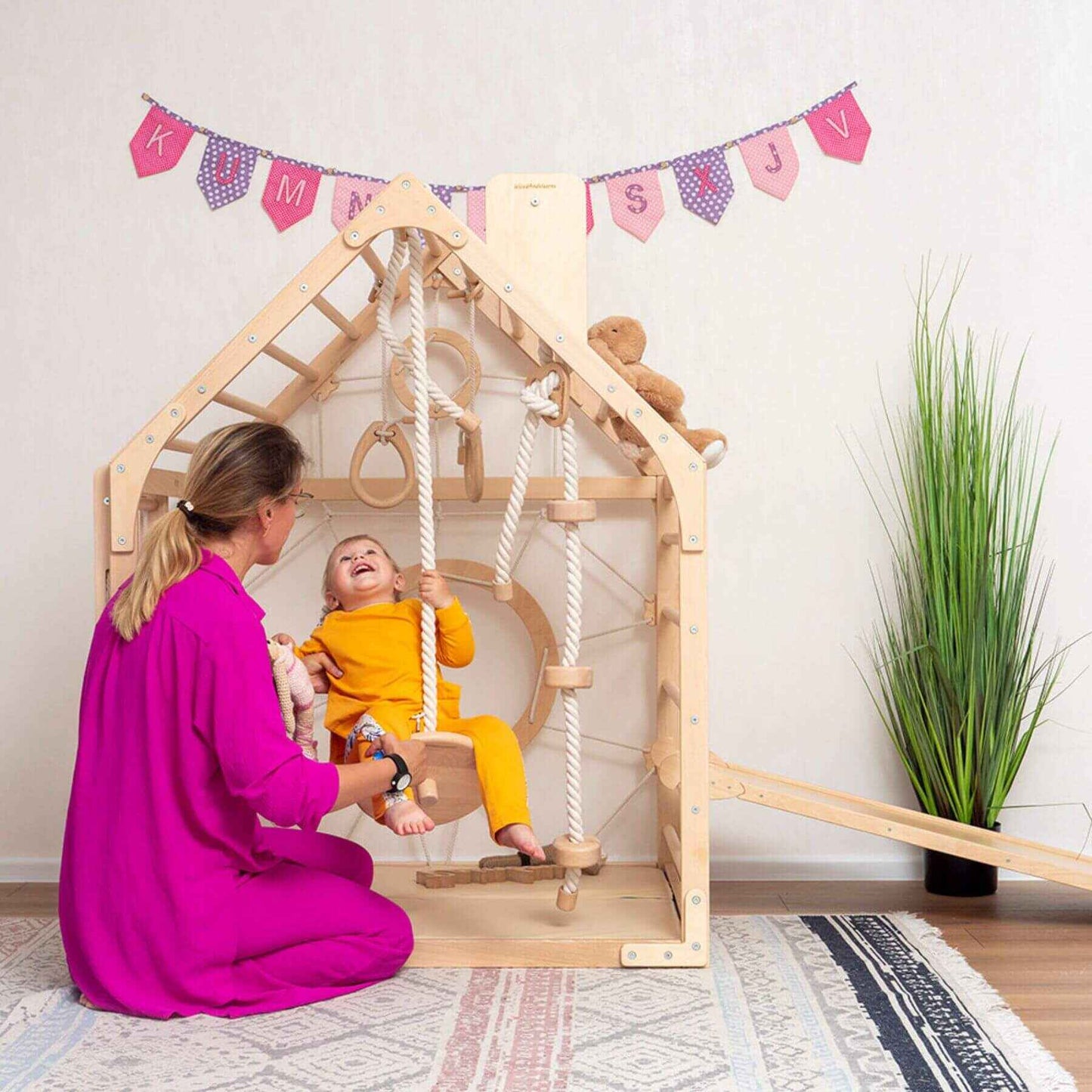 Girl Playing on Wood and Hearts Wooden Climbing Playhouse w/ Ramp, 3 Ropes