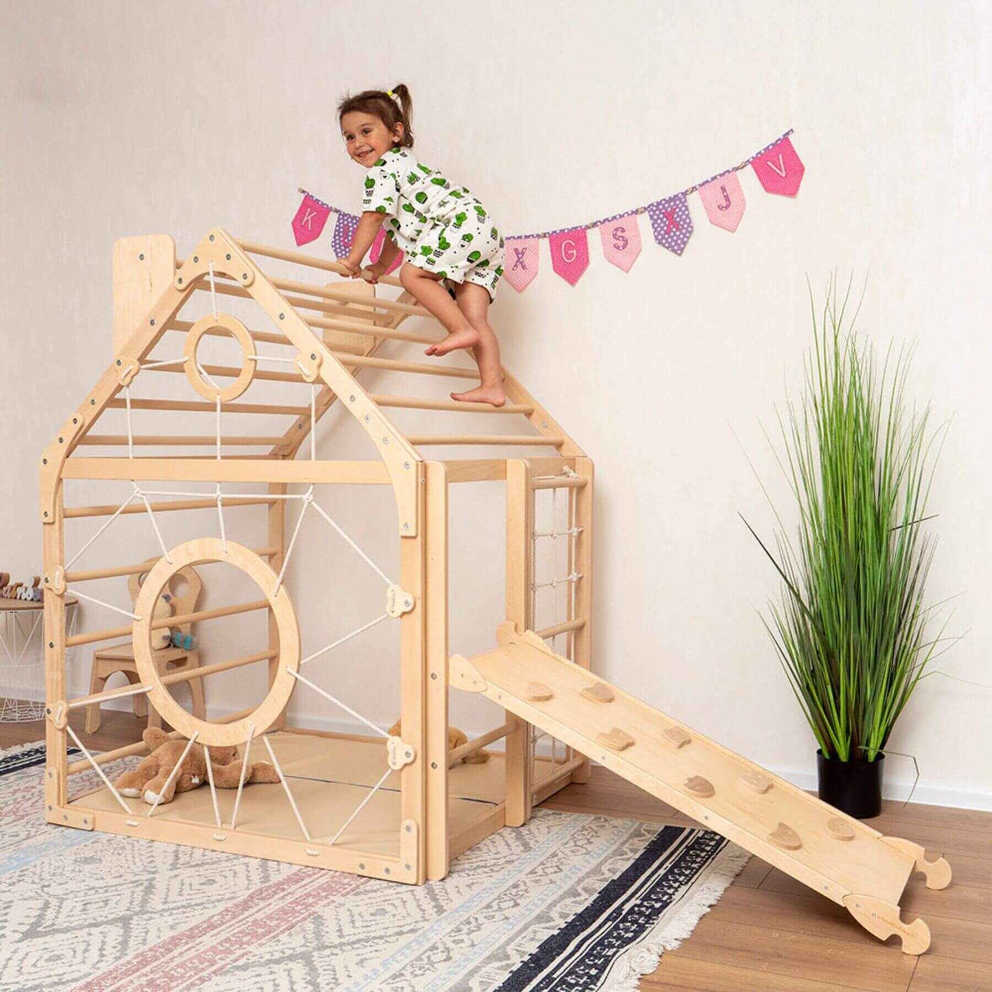 Girl Playing on Wood and Hearts Wooden Climbing Playhouse Natural