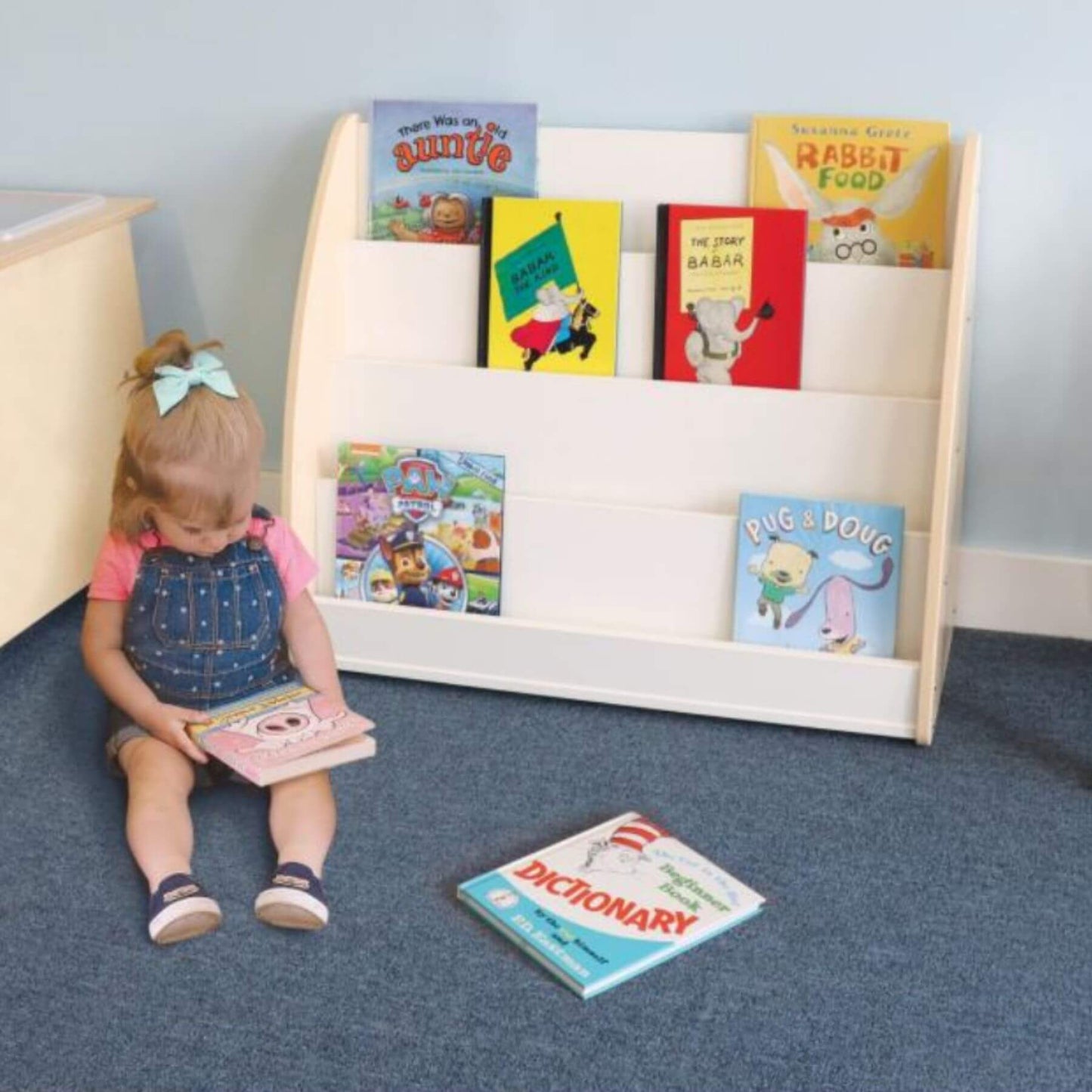 Girl Reading Next to Whitney Brothers New Wave Melamine Book Display
