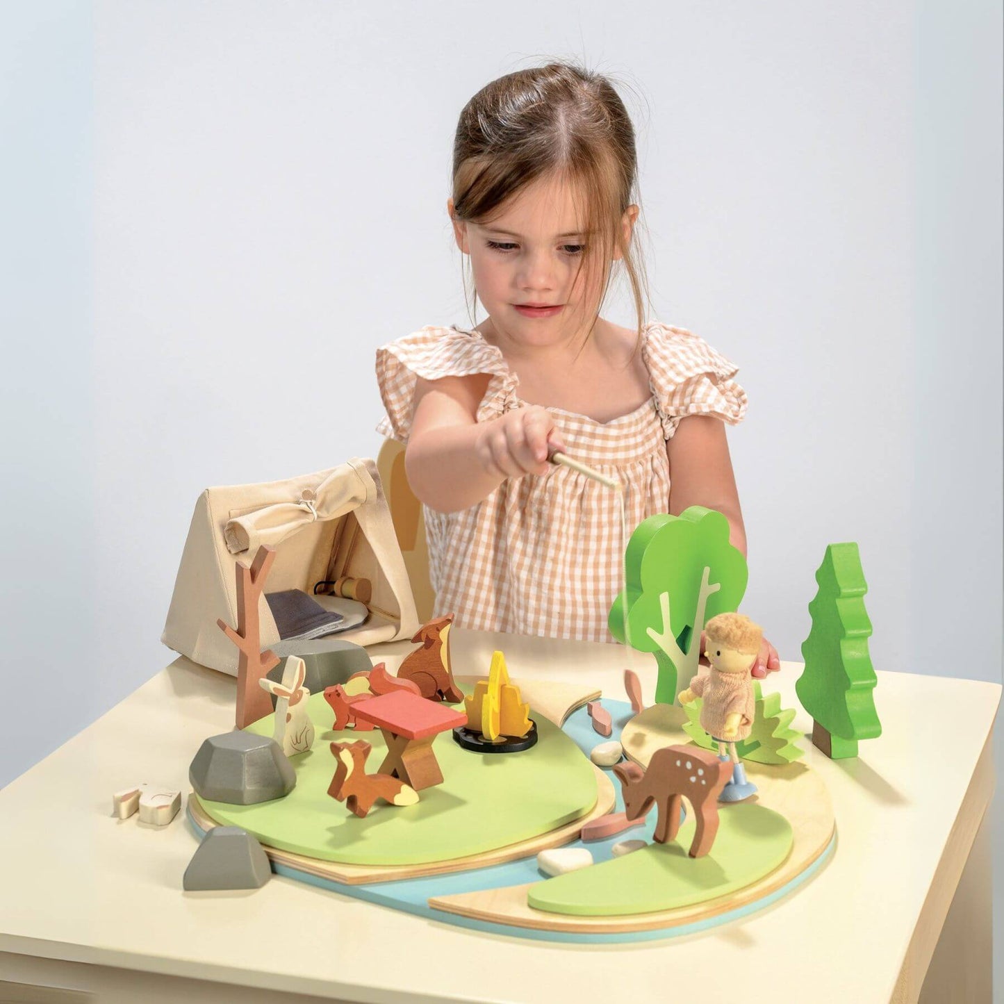 Child playing with Tender Leaf Wildlife Camping Playset on a table