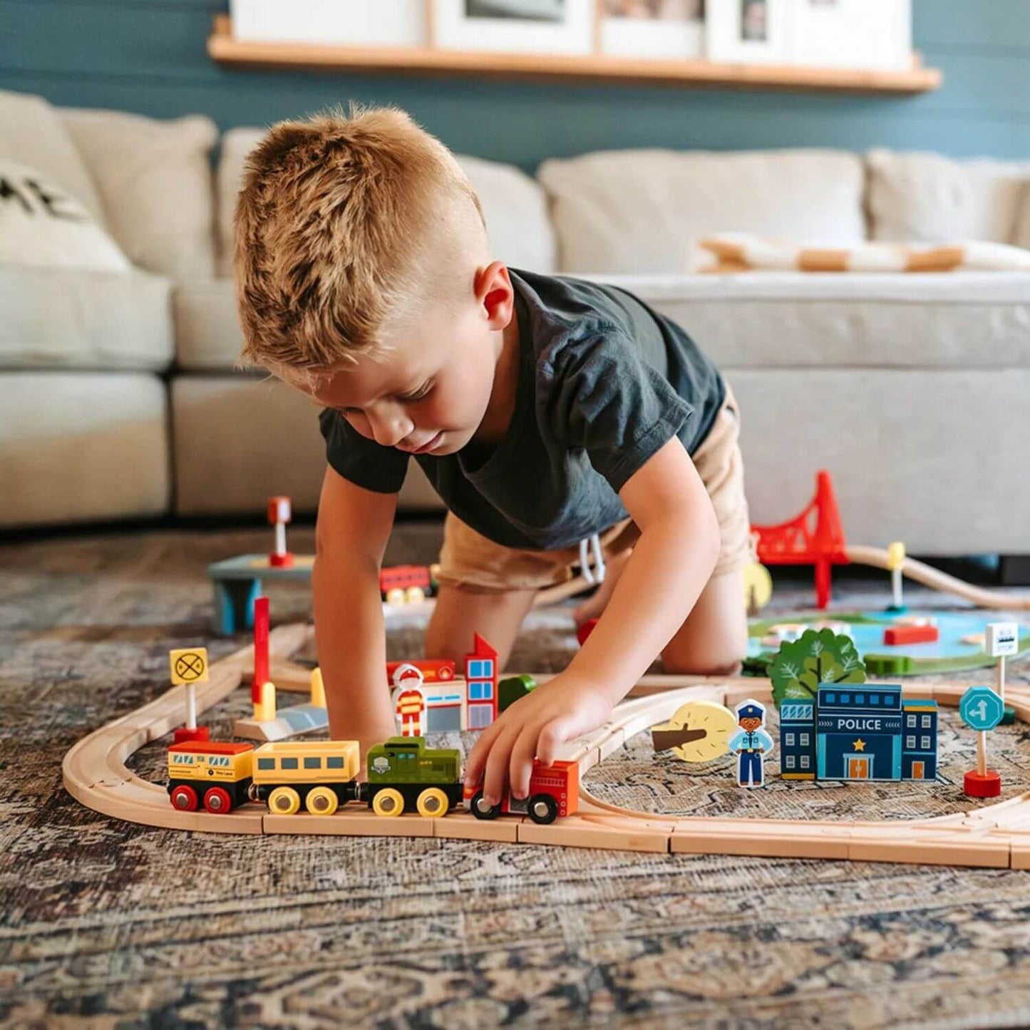 Boy Playing Tiny Land® Wooden Train Set 110 Pcs