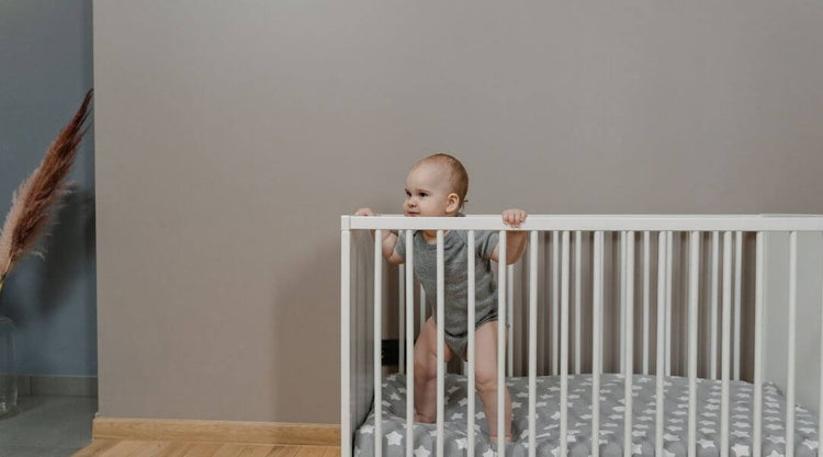 baby standing in crib