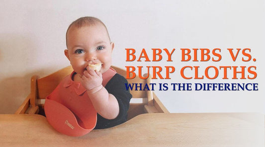 baby wearing a bib eating at table