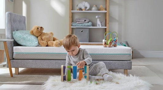 Baby playing next to bed