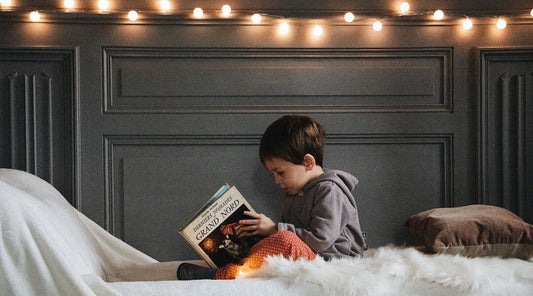 boy reading on bed