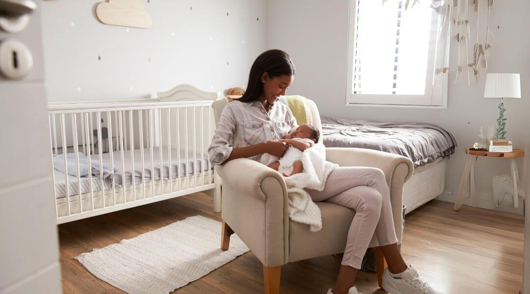 Mom nursing baby on a nursery chair