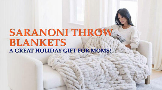 woman sitting on a couch, under a Saranoni blanket