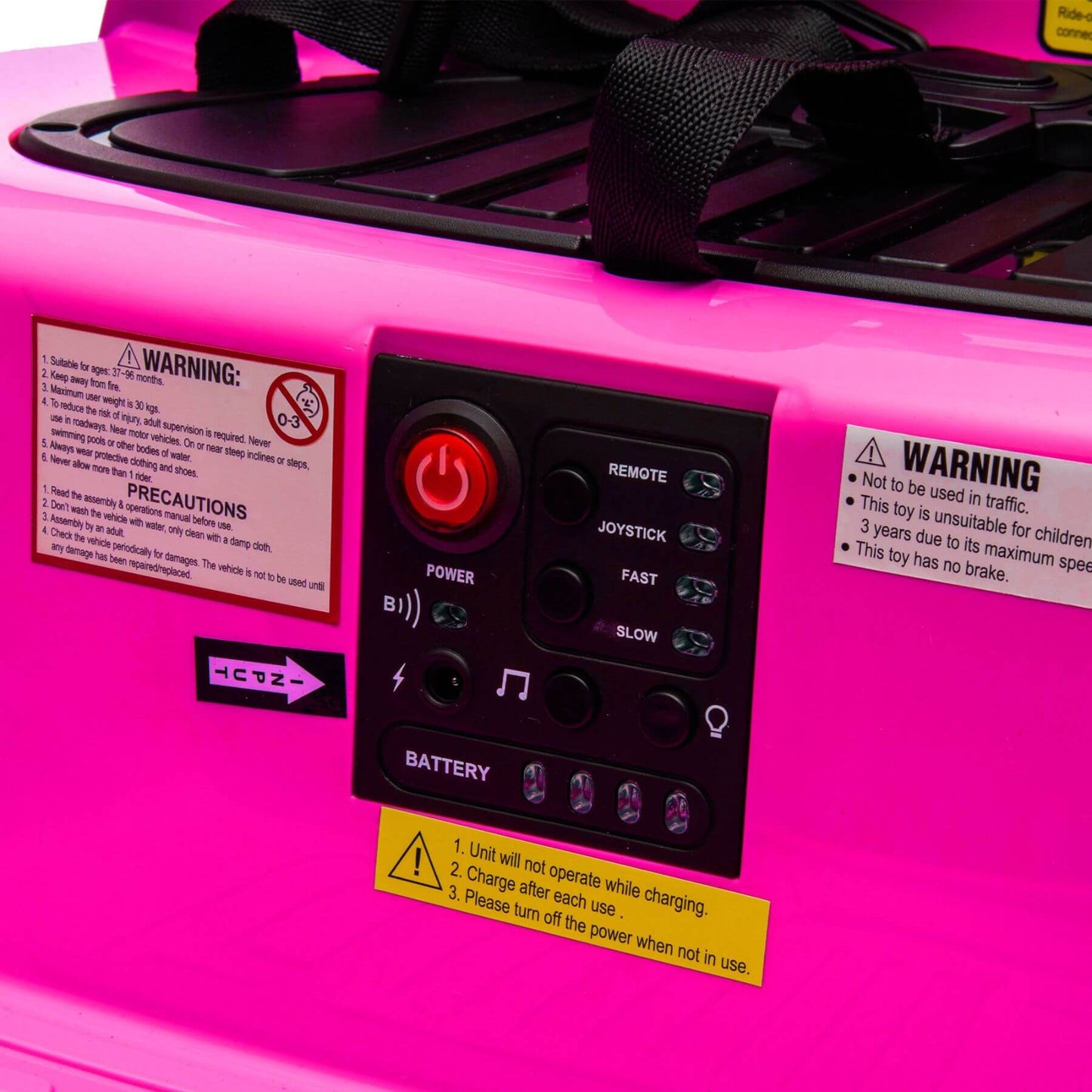 Control panel with warning labels on a pink toy vehicle
