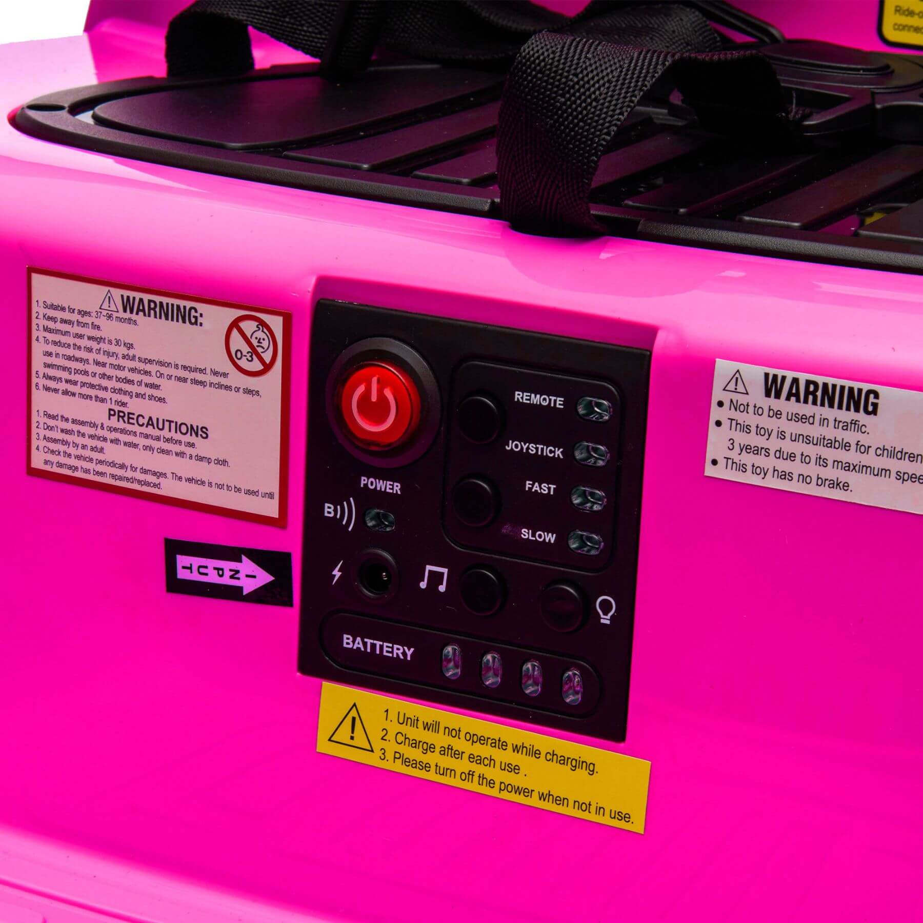 Control panel with warning labels on a pink toy vehicle
