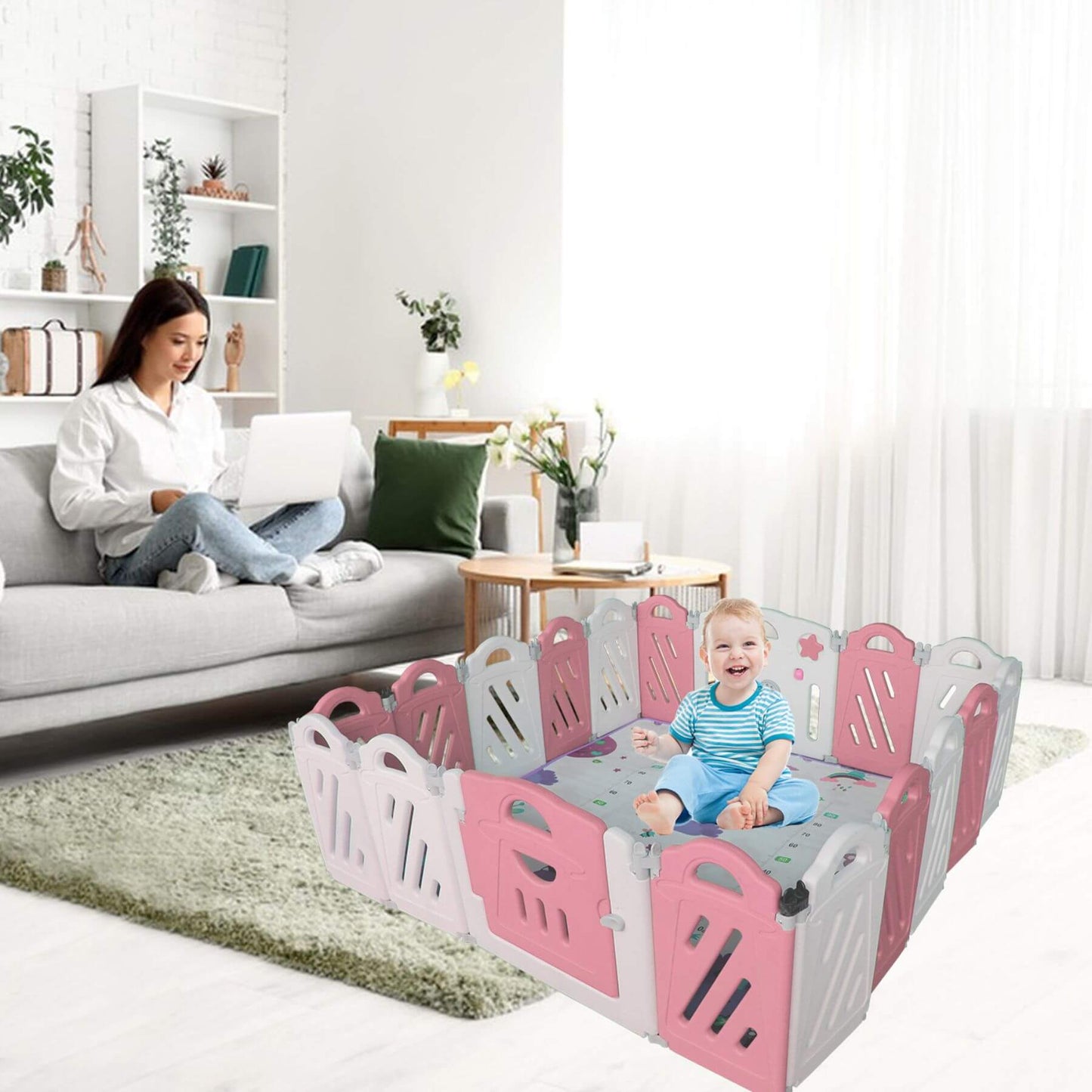 Child in MGSPORT 20+2 Panel Foldable Baby Playpen, Pink + White with a woman sitting on a couch in a living room.