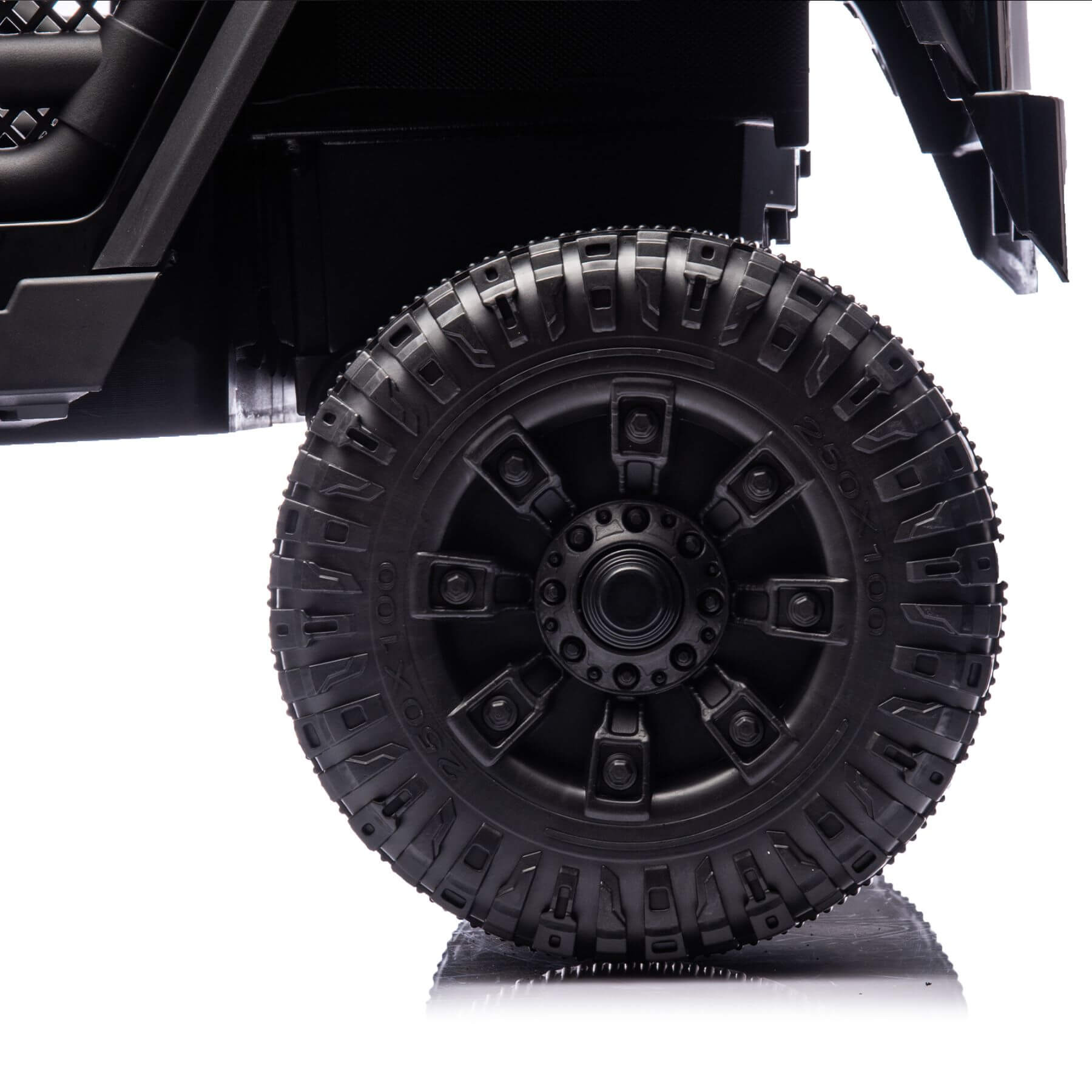 Close-up of a black off-road vehicle tire on a white background