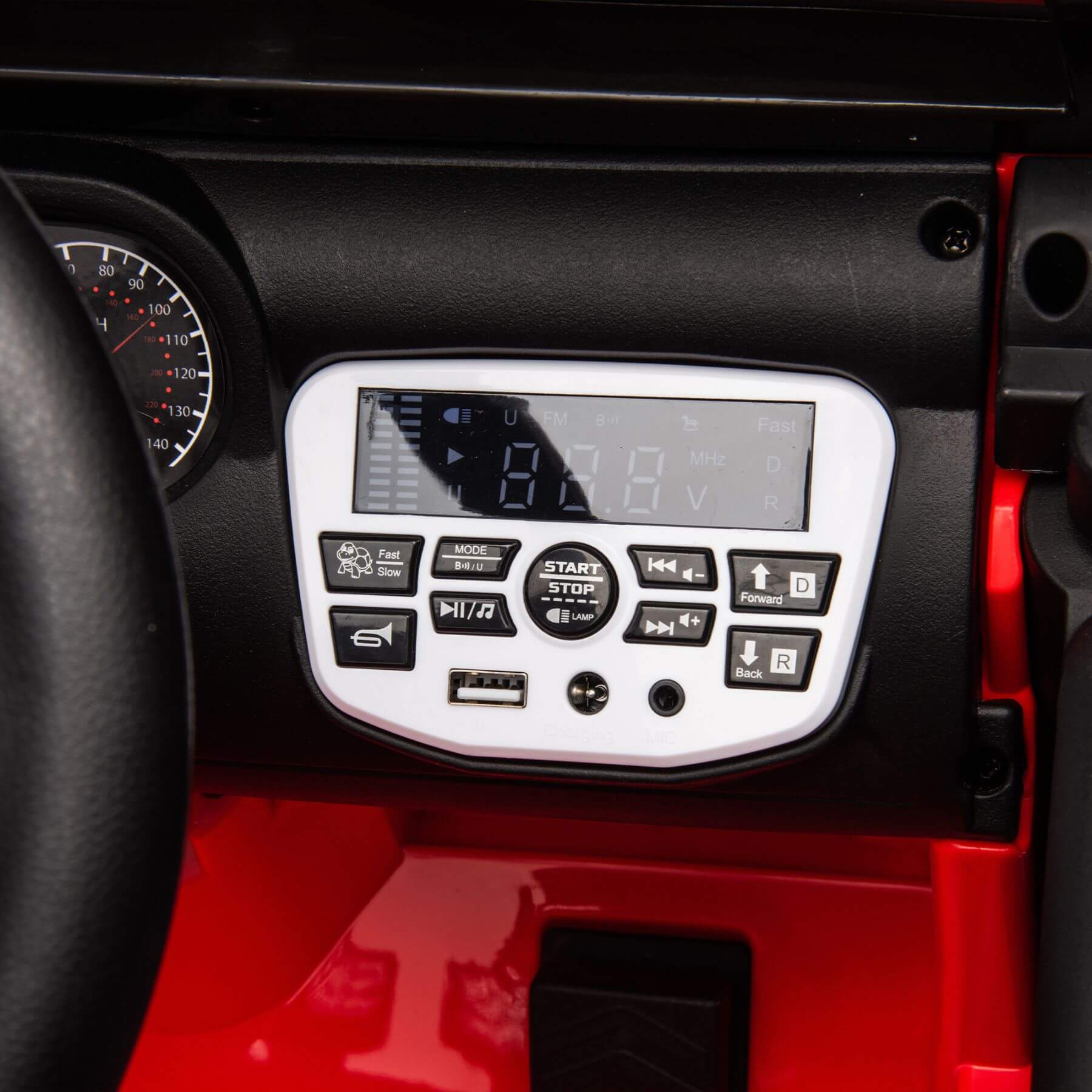 Control panel with digital display and buttons on a red and black vehicle interior.