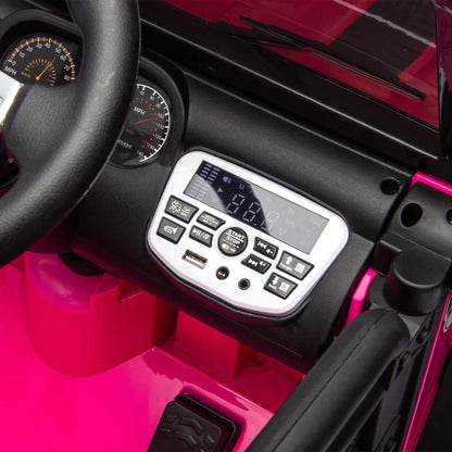 Close-up of a pink toy car's interior with steering wheel, dashboard, and control panel.