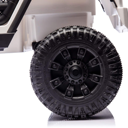 Close-up of a black tire with tread pattern on a white background