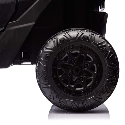 Black off-road vehicle tire with detailed tread pattern on a white background