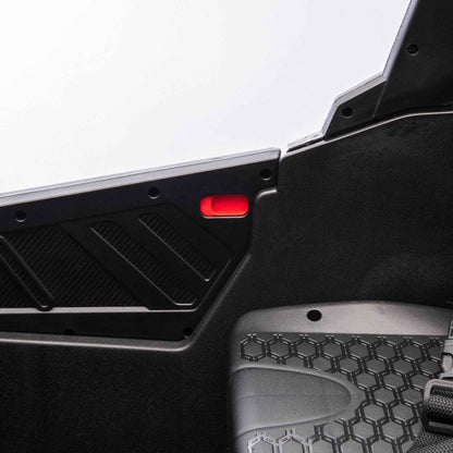 Toy car interior with open door and red light on a white background