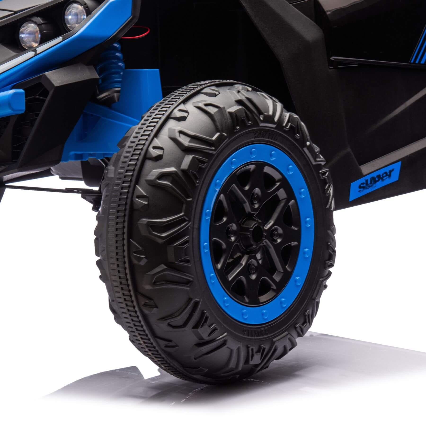 Close-up of a toy car tire with blue rim on a white background