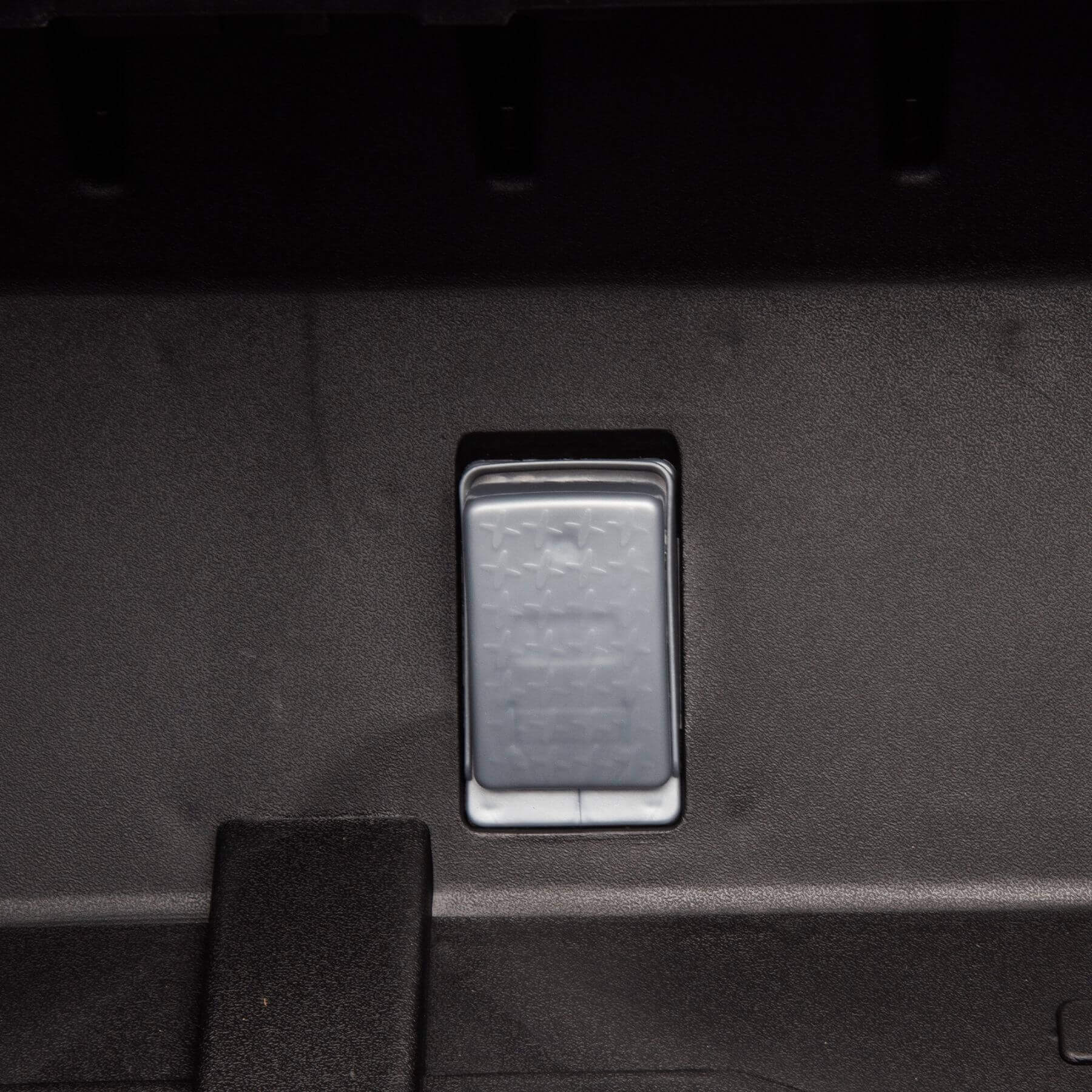 Metallic switch or button on a dark textured surface