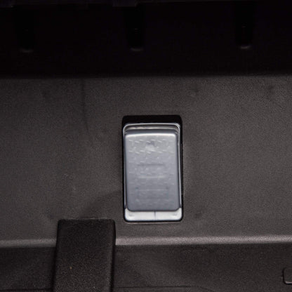 Metallic switch or button on a dark textured surface