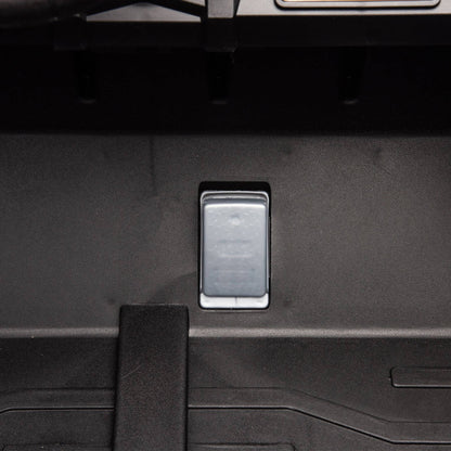 Close-up of a car's open trunk with a footrest inside