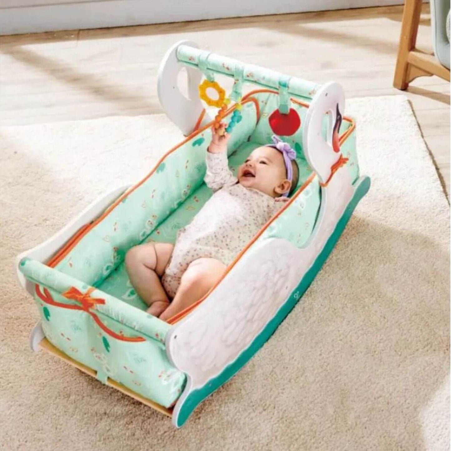 Baby Lying in Hape 2-in-1 Swan Seat