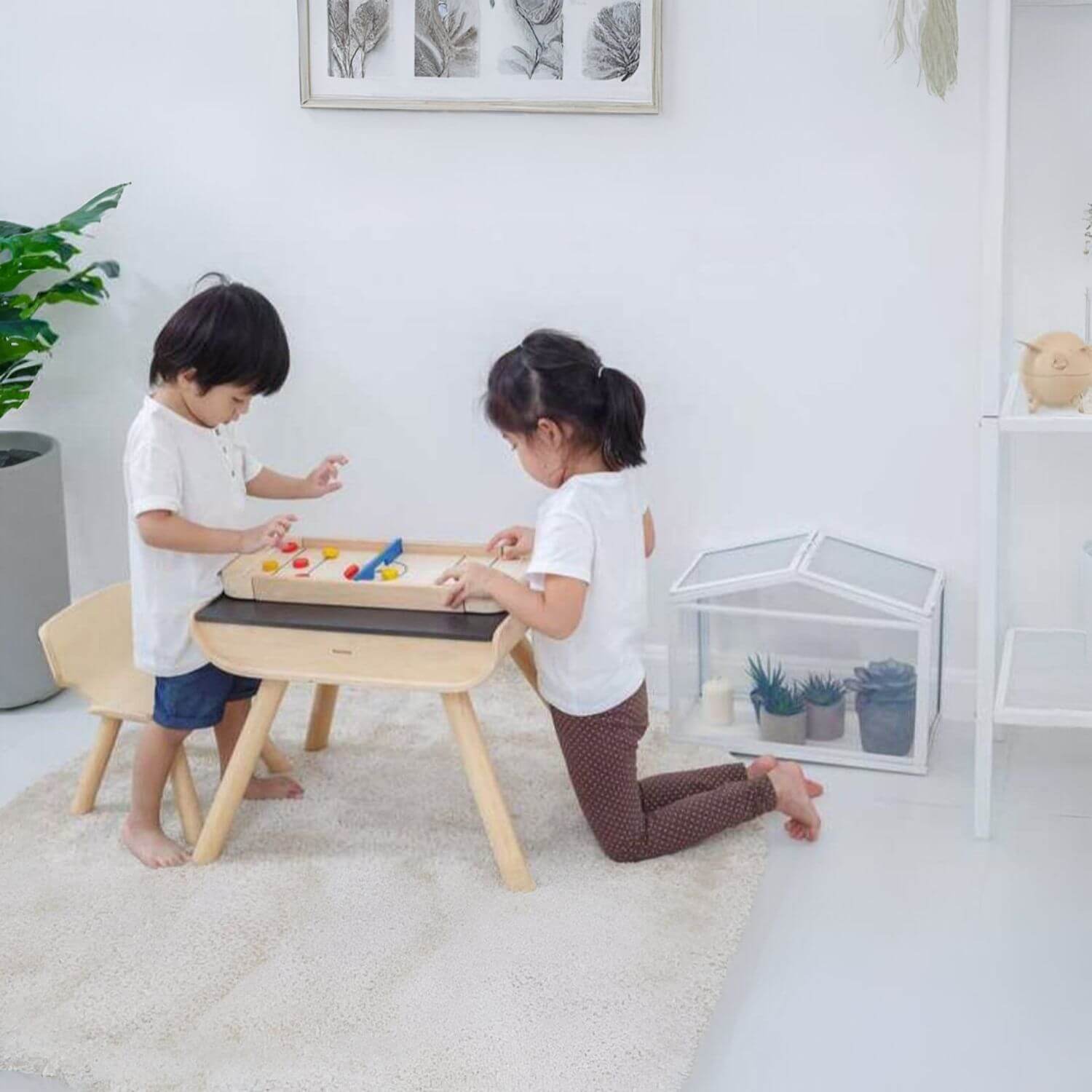 Kids Playing PlanToys 2-In-1 Shuffleboard Game